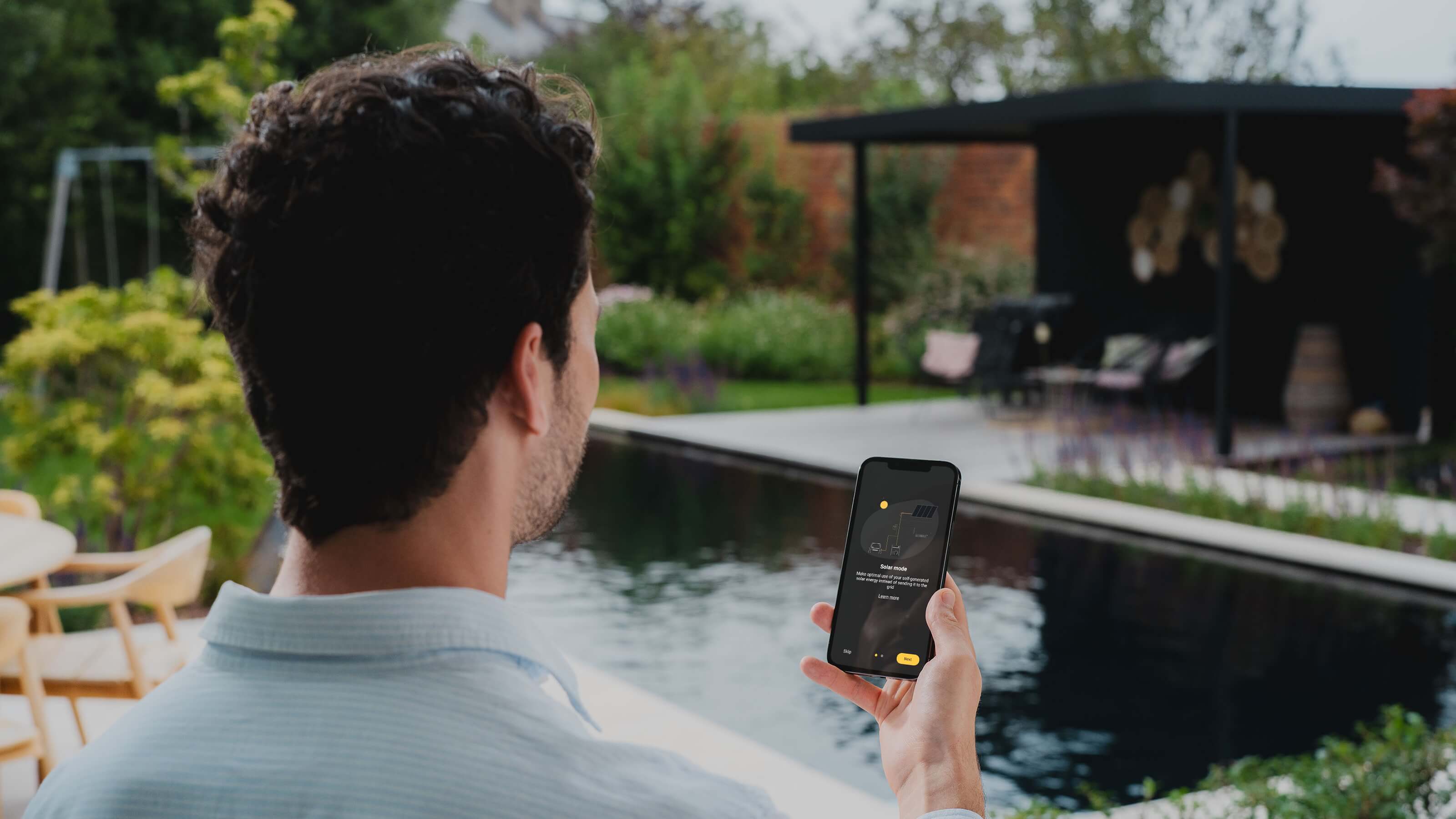 Solar panels on gable roof with Niko Home app in foreground